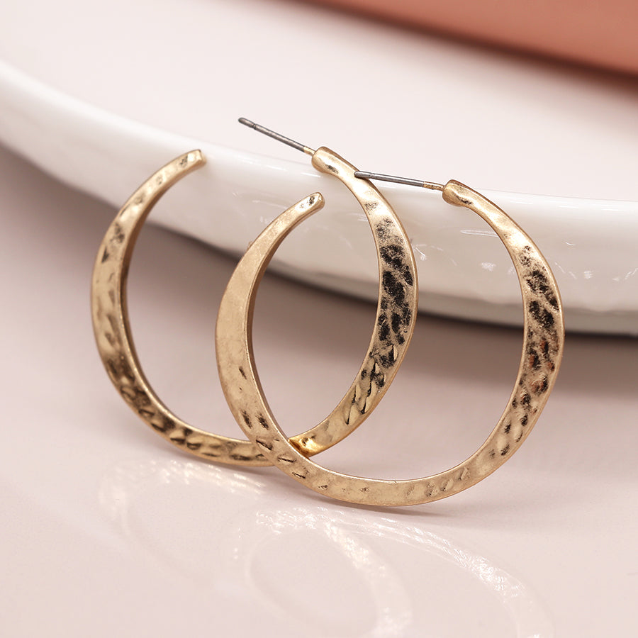 Worn gold irregular hammered open hoop earrings