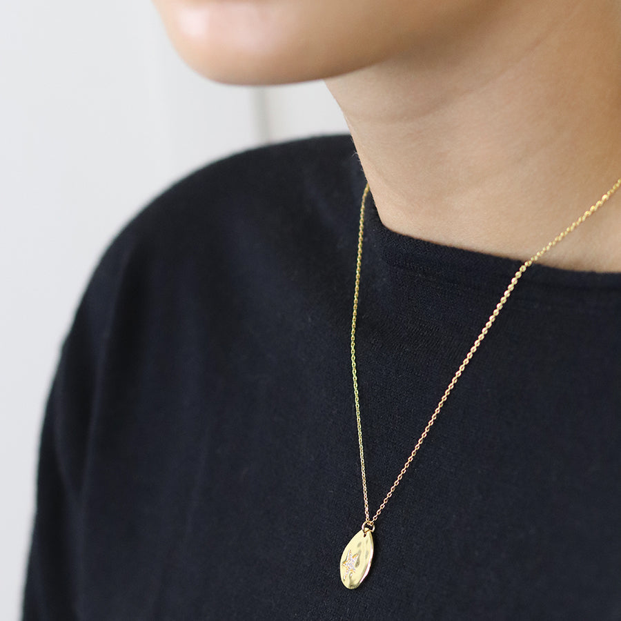 Faux gold organic polished teardrop necklace with crystal star imprint