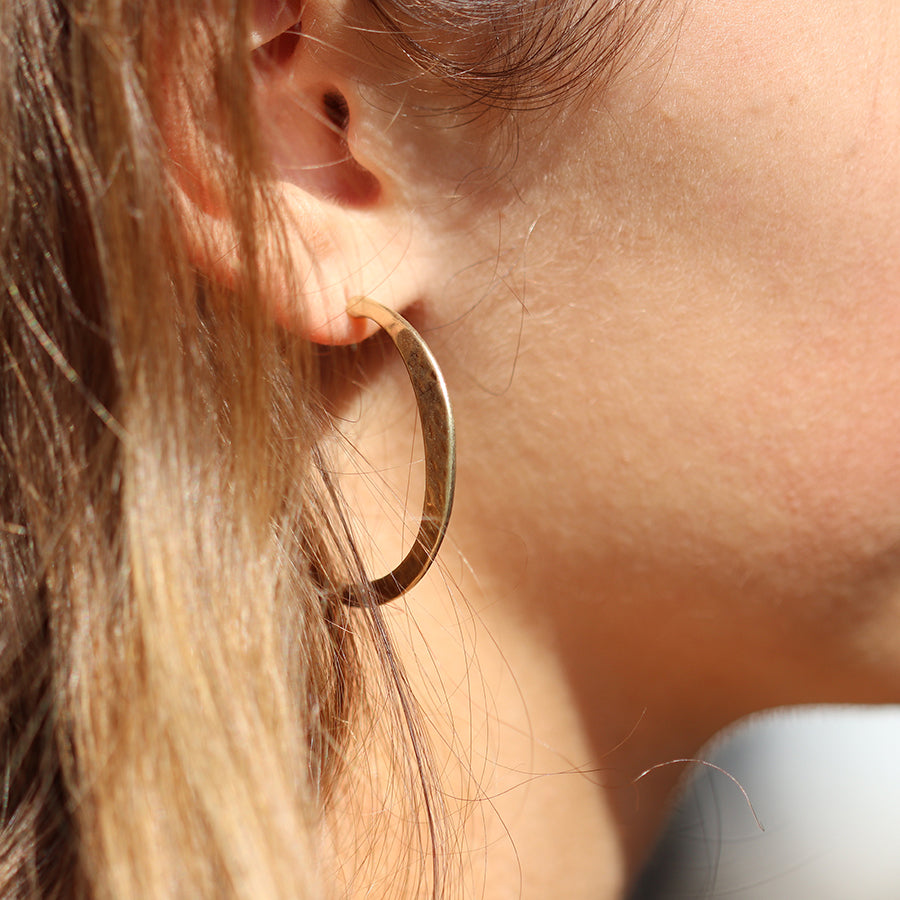 Worn gold irregular hammered open hoop earrings